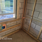 Pre-drywall inspection showing electrical wiring, nail plates, window framing, and furring strips inside a new construction home in Central Florida.