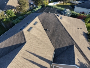 Drone photo of shingle roof showing typical aging and ventilation components.
