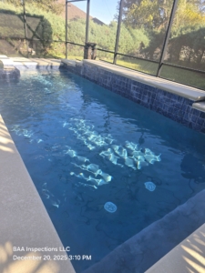 Pool interior surface showing discoloration in underwater areas.