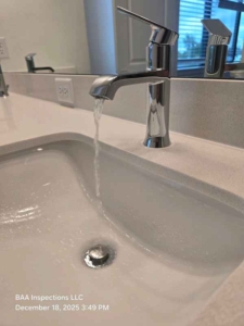 Bathroom sink faucet exhibiting low water pressure during functional testing at a final new-construction home inspection.